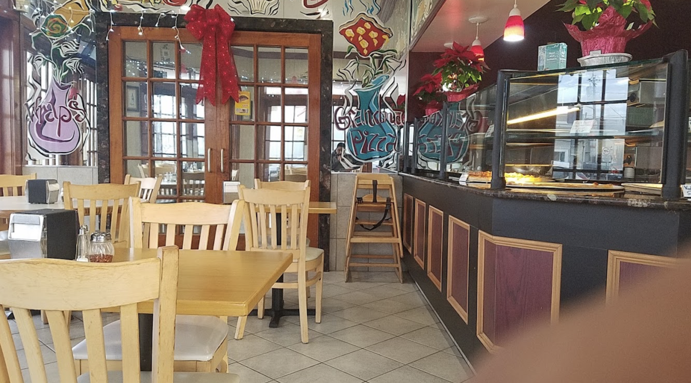 Dining room and pizza counter inside Farfalle Pizzeria